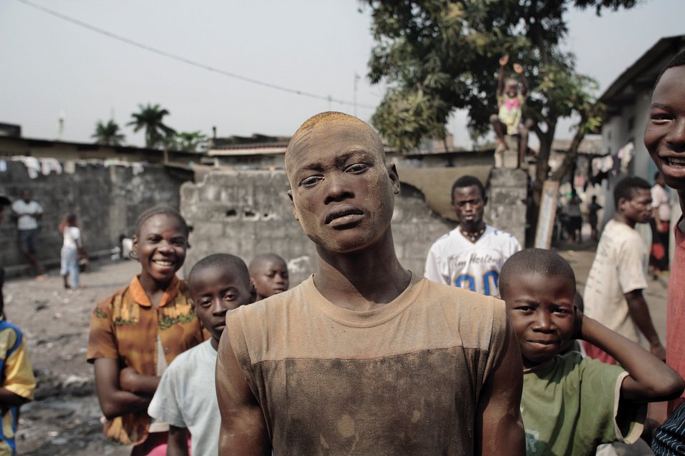 A sawmill worker poses outside a political meeting, suburban Kinshasa, 2006