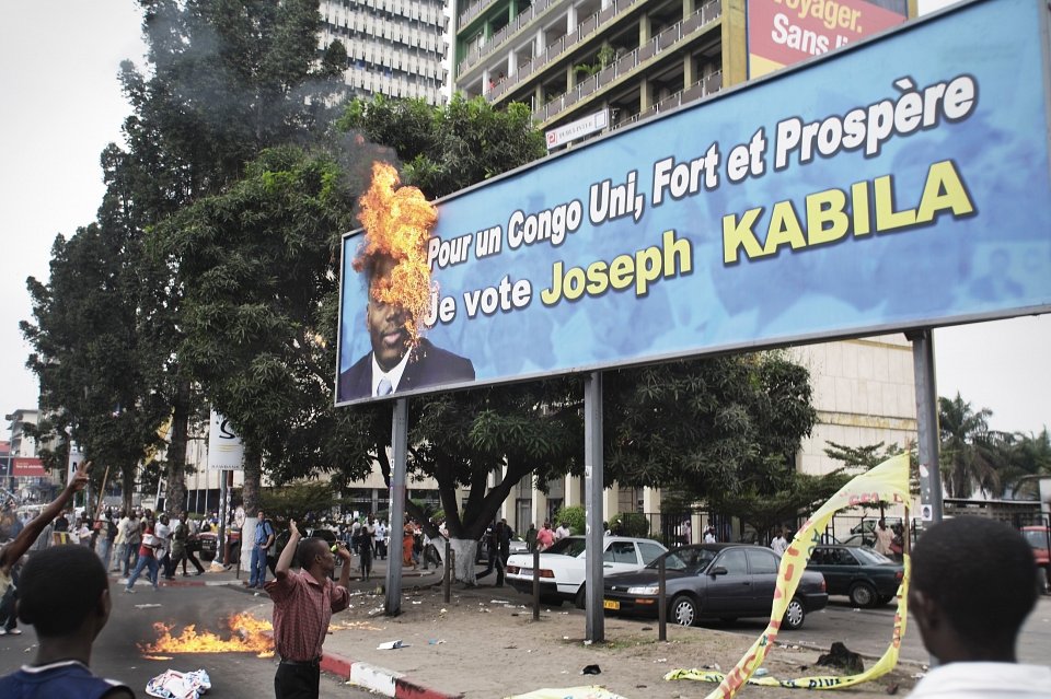 Followers of Etienne Tshisikedi, calling for a boycott of the elections, burn a Kabila election billboard, central Kinshasa, 2006